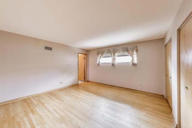 5215 S Meade Ave, Chicago, IL 60638 - empty room with light wood finished floors and baseboards