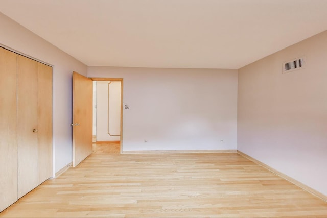 5215 S Meade Ave, Chicago, IL 60638 - unfurnished bedroom with light wood-type flooring and a closet