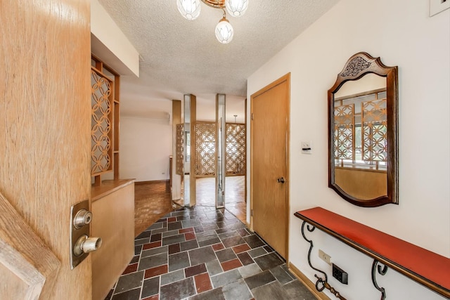5215 S Meade Ave, Chicago, IL 60638 - corridor featuring stone tile floors and a textured ceiling