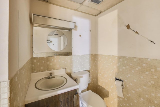 5215 S Meade Ave, Chicago, IL 60638 - bathroom with vanity, tile walls, and a wainscoted wall