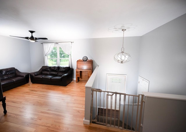 165 E Clay St, El Paso, IL 61738 - living room featuring a chandelier, light wood-style flooring, and ceiling fan