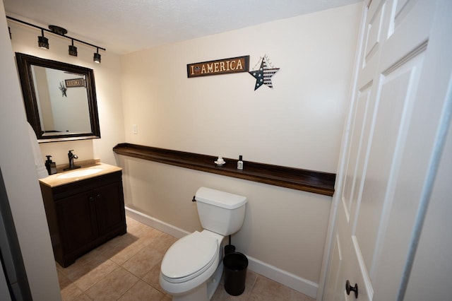165 E Clay St, El Paso, IL 61738 - half bathroom featuring rail lighting, vanity, and tile patterned floors