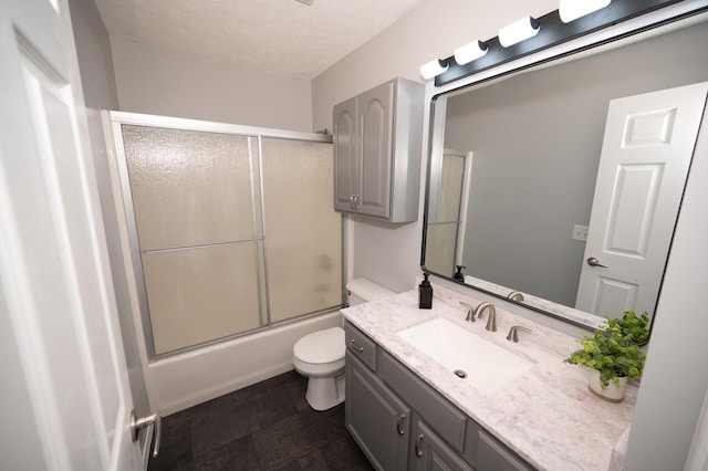 165 E Clay St, El Paso, IL 61738 - bathroom featuring vanity, enclosed tub / shower combo, and a textured ceiling