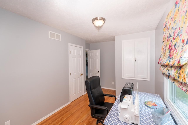 165 E Clay St, El Paso, IL 61738 - home office featuring light wood-type flooring and baseboards