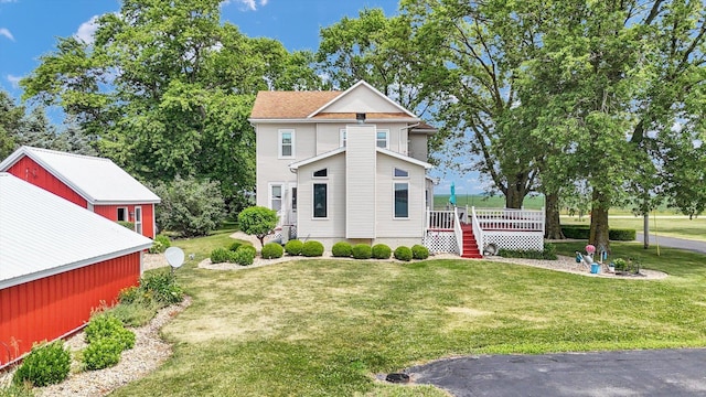 887 N 1100e Rd, Melvin, IL 60952 - view of front facade featuring a front lawn and a wooden deck