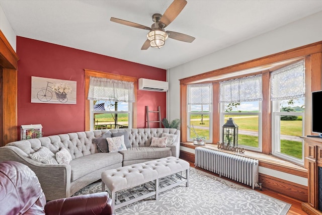 887 N 1100e Rd, Melvin, IL 60952 - living room featuring radiator heating unit, a wall unit AC, wood finished floors, and ceiling fan