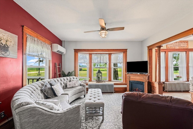 887 N 1100e Rd, Melvin, IL 60952 - living area with radiator heating unit, a wall mounted AC, ceiling fan, and plenty of natural light