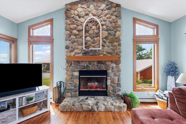 887 N 1100e Rd, Melvin, IL 60952 - living area featuring a fireplace, healthy amount of natural light, and wood finished floors