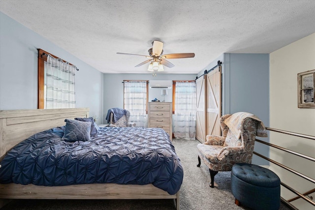 887 N 1100e Rd, Melvin, IL 60952 - bedroom featuring carpet, ceiling fan, a textured ceiling, an AC wall unit, and a barn door