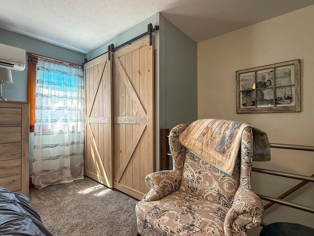 887 N 1100e Rd, Melvin, IL 60952 - living area with carpet floors, an AC wall unit, a barn door, and a textured ceiling