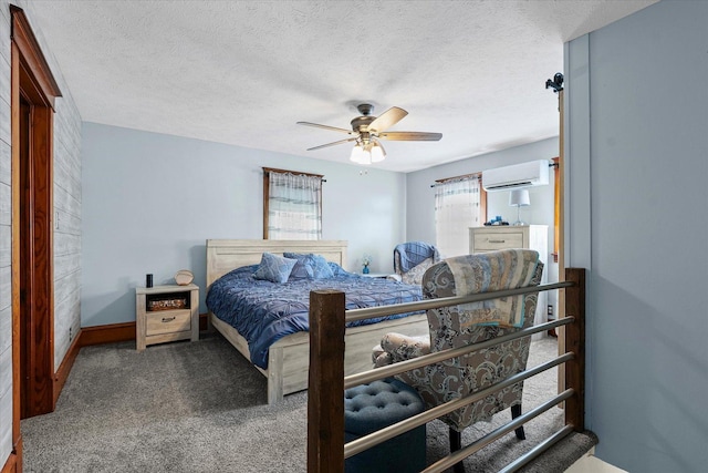 887 N 1100e Rd, Melvin, IL 60952 - bedroom featuring an AC wall unit, carpet, a ceiling fan, and a textured ceiling