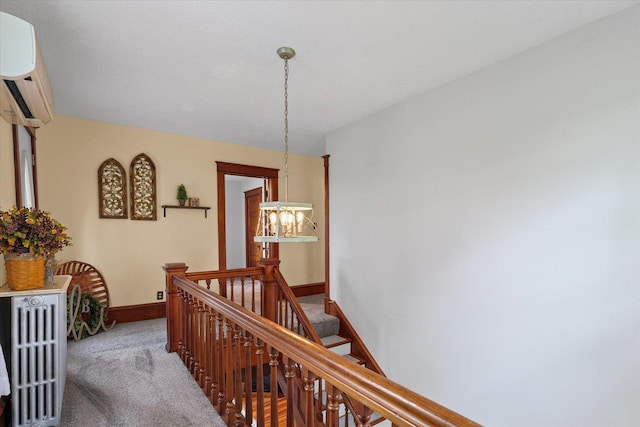 887 N 1100e Rd, Melvin, IL 60952 - hallway with a chandelier, carpet floors, an AC wall unit, and an upstairs landing