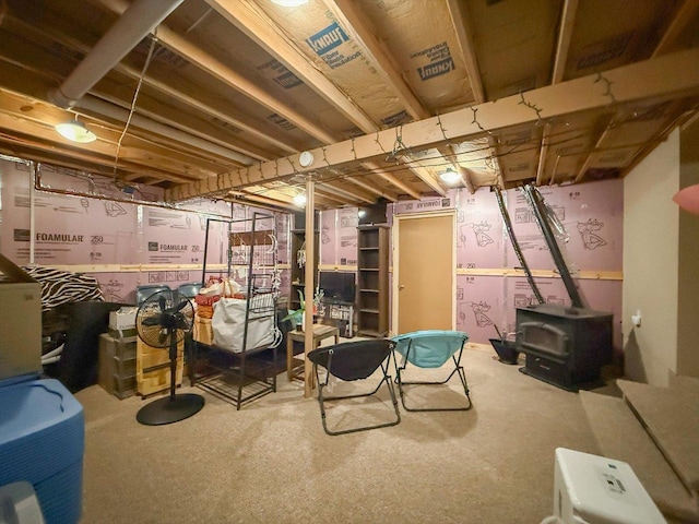 887 N 1100e Rd, Melvin, IL 60952 - unfinished basement featuring a wood stove and carpet