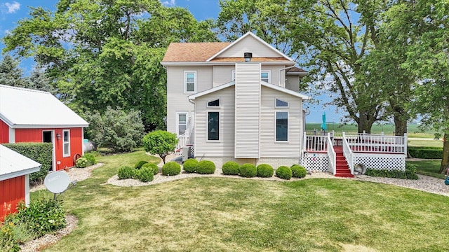 887 N 1100e Rd, Melvin, IL 60952 - view of home's exterior with a yard, a wooden deck, and an outbuilding