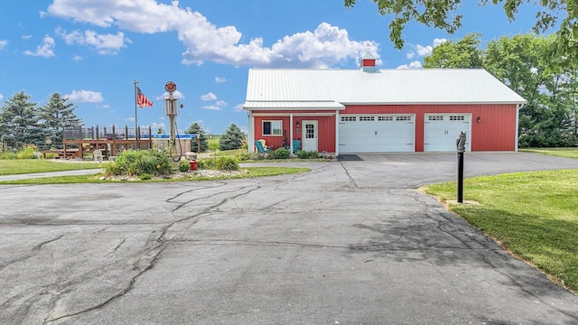 887 N 1100e Rd, Melvin, IL 60952 - view of front of house with a front lawn and a metal roof