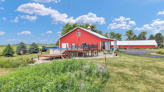 887 N 1100e Rd, Melvin, IL 60952 - rear view of property with a wooden deck, a yard, and a chimney