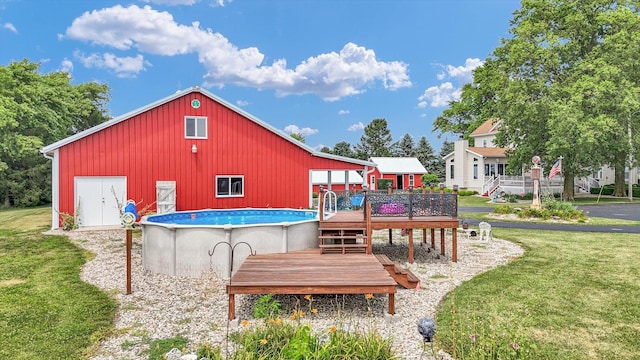 887 N 1100e Rd, Melvin, IL 60952 - rear view of house with a wooden deck, a lawn, and an outdoor pool