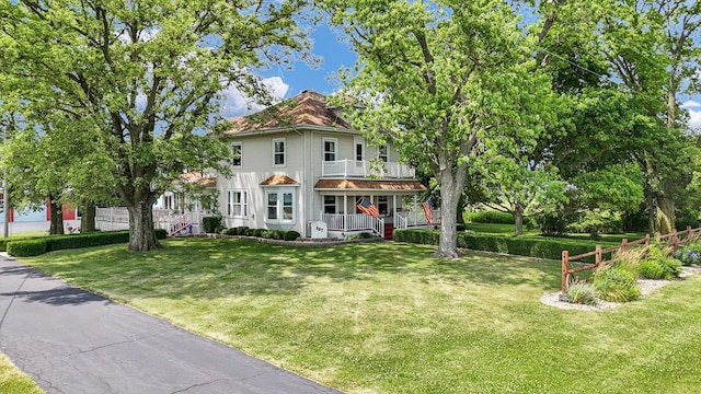 887 N 1100e Rd, Melvin, IL 60952 - view of front facade featuring a porch, a front lawn, and a balcony