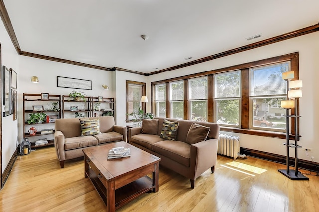 3740 N Whipple St, Chicago, IL 60618 - living area with radiator, light wood finished floors, and ornamental molding