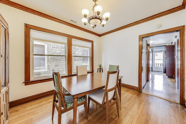3740 N Whipple St, Chicago, IL 60618 - dining room featuring a chandelier, crown molding, and light wood-type flooring