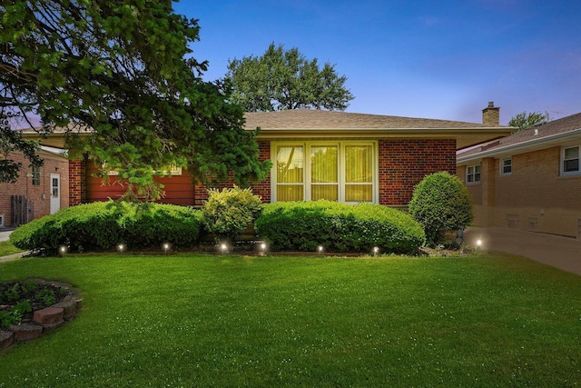 5504 Oakdale Dr, Oak Lawn, IL 60453 - view of front of home featuring brick siding, a front yard, and a chimney