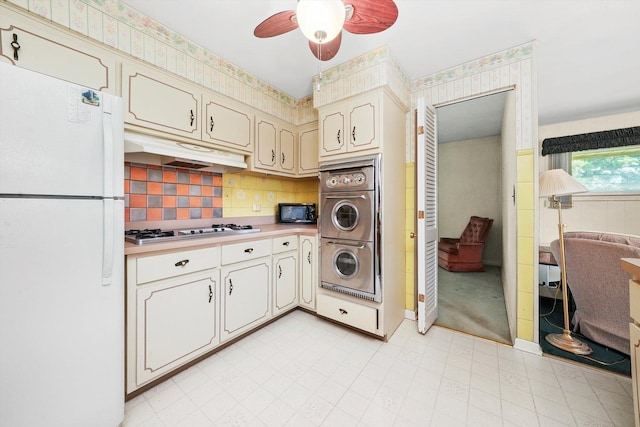 5504 Oakdale Dr, Oak Lawn, IL 60453 - kitchen featuring freestanding refrigerator, gas stovetop, under cabinet range hood, wall oven, and black microwave