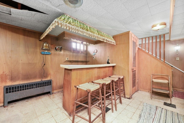 5504 Oakdale Dr, Oak Lawn, IL 60453 - indoor dry bar with tile patterned floors, radiator, and wood walls