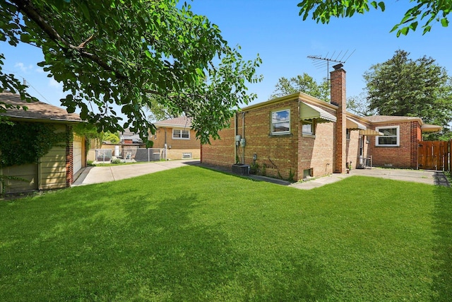 5504 Oakdale Dr, Oak Lawn, IL 60453 - rear view of house with a chimney, brick siding, and a patio area