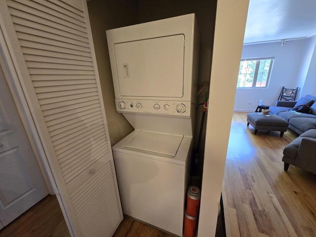 6400 N Sacramento Ave Unit 205, Chicago, IL 60645 - laundry area with stacked washer and clothes dryer and wood finished floors