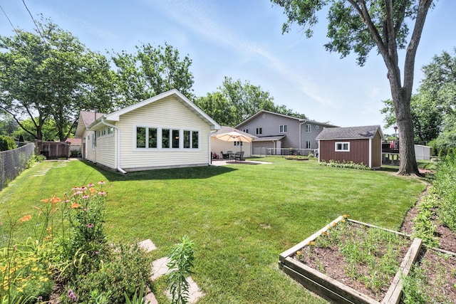 2S624 Gray Ave, Lombard, IL 60148 - rear view of house with a vegetable garden, a fenced backyard, a storage shed, and a patio