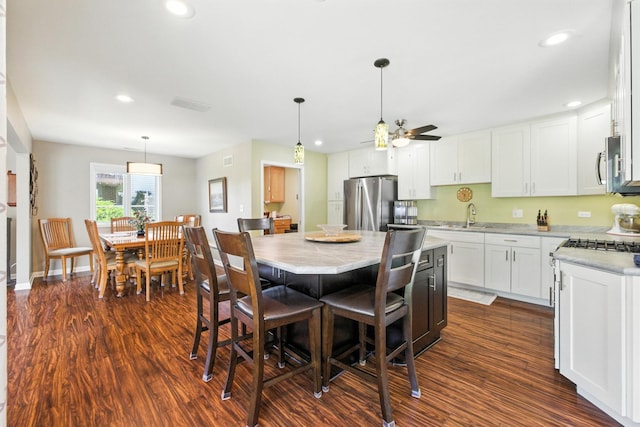 2S624 Gray Ave, Lombard, IL 60148 - kitchen with dark wood finished floors, a ceiling fan, appliances with stainless steel finishes, white cabinetry, and hanging light fixtures