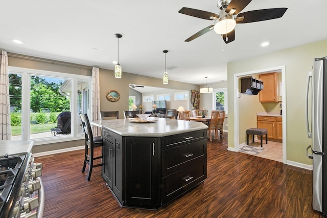 2S624 Gray Ave, Lombard, IL 60148 - kitchen with dark cabinets, appliances with stainless steel finishes, dark wood finished floors, light countertops, and decorative light fixtures