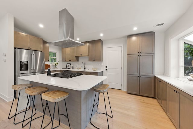787 Bluejay Cir, Elk Grove Village, IL 60007 - kitchen with island exhaust hood, high end refrigerator, light wood-type flooring, a breakfast bar, and vaulted ceiling