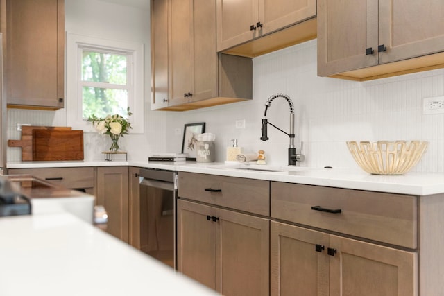 787 Bluejay Cir, Elk Grove Village, IL 60007 - kitchen featuring backsplash, light countertops, and stainless steel dishwasher