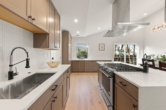 787 Bluejay Cir, Elk Grove Village, IL 60007 - kitchen with island range hood, high end stove, light wood finished floors, decorative backsplash, and light stone countertops