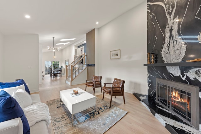 787 Bluejay Cir, Elk Grove Village, IL 60007 - living area with wood finished floors, recessed lighting, a fireplace, stairs, and a chandelier