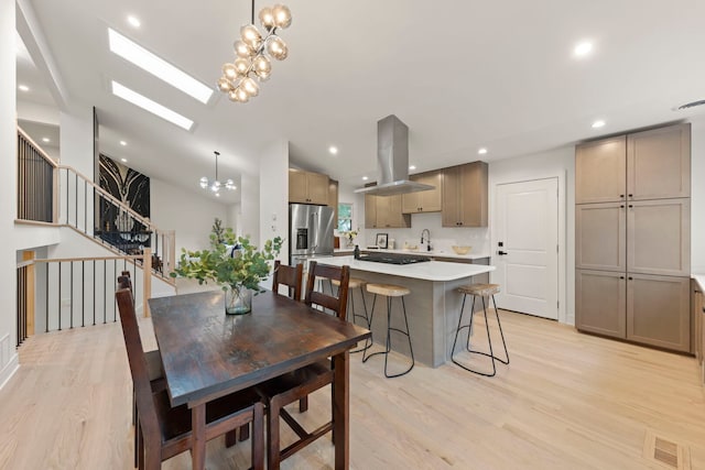 787 Bluejay Cir, Elk Grove Village, IL 60007 - dining area with a chandelier, light wood-style floors, recessed lighting, a skylight, and stairway