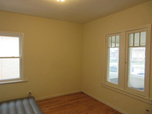 7522 S Merrill Ave, Chicago, IL 60649 - spare room with healthy amount of natural light and wood finished floors