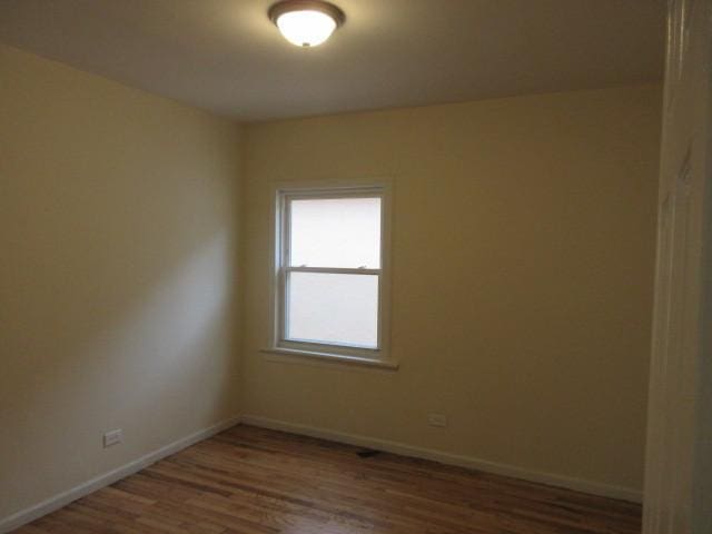 7522 S Merrill Ave, Chicago, IL 60649 - spare room featuring wood finished floors and baseboards