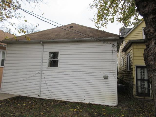 7522 S Merrill Ave, Chicago, IL 60649 - view of property exterior with roof with shingles