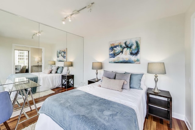 30 E Huron St Unit 2602, Chicago, IL 60611 - bedroom with wood finished floors, rail lighting, and a closet