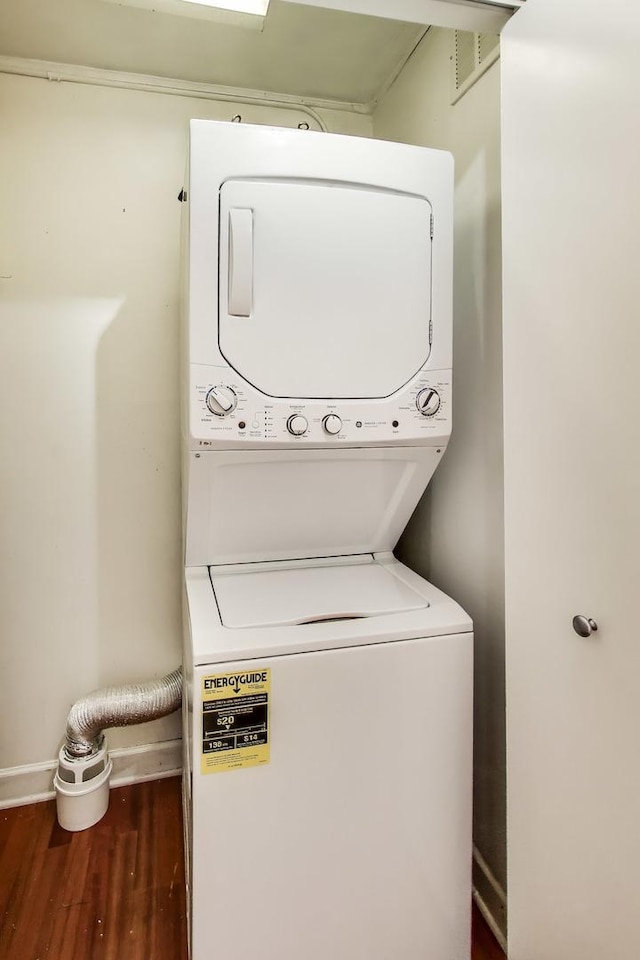 30 E Huron St Unit 2602, Chicago, IL 60611 - washroom featuring stacked washer and clothes dryer and wood finished floors
