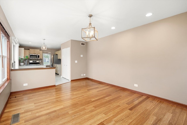 1097 Dovercliff Way, Crystal Lake, IL 60014 - unfurnished living room with a chandelier, light wood-style flooring, and recessed lighting