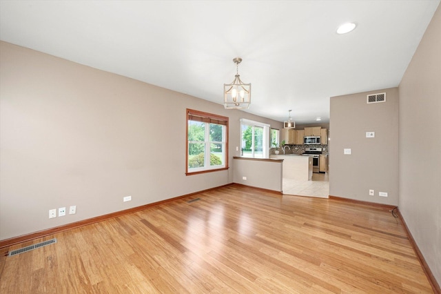 1097 Dovercliff Way, Crystal Lake, IL 60014 - unfurnished living room with a chandelier, light wood finished floors, and recessed lighting