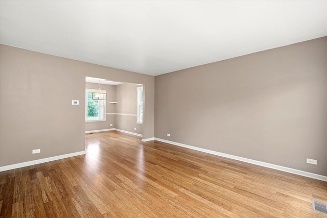 1097 Dovercliff Way, Crystal Lake, IL 60014 - spare room featuring light wood-style floors and a chandelier