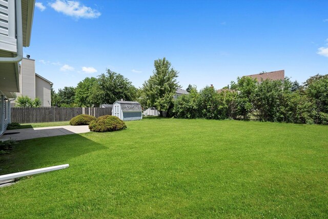 1097 Dovercliff Way, Crystal Lake, IL 60014 - fenced backyard with a storage unit and a patio