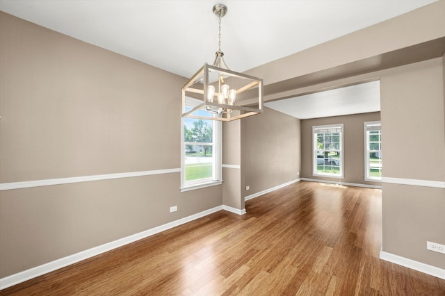 1097 Dovercliff Way, Crystal Lake, IL 60014 - empty room with a chandelier, wood finished floors, and plenty of natural light