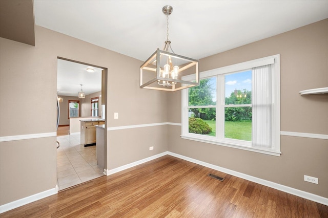 1097 Dovercliff Way, Crystal Lake, IL 60014 - spare room featuring a chandelier and light wood-type flooring