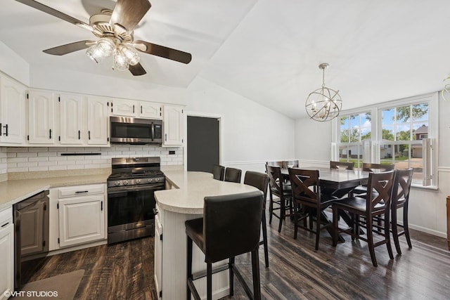 516 W Weathersfield Way, Schaumburg, IL 60193 - kitchen featuring appliances with stainless steel finishes, lofted ceiling, dark wood-style floors, backsplash, and light countertops