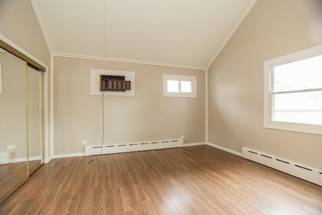 1103 Circle Ave, Forest Park, IL 60130 - unfurnished bedroom with a baseboard radiator, vaulted ceiling, a wall mounted AC, wood finished floors, and ornamental molding